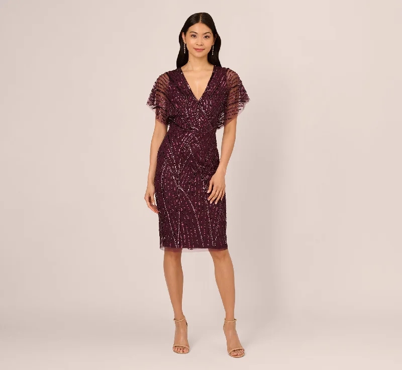 Trendy wedding guest dresses for a cocktail party reception -Beaded Surplice Midi Dress With Dolman Sleeves In Deep Amethyst Trendy wedding guest dresses for a cocktail party reception -Beaded Surplice Midi Dress With Dolman Sleeves In Deep Amethyst